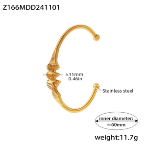 Detail view of gold stainless steel spring cuff bracelet with 11mm width and 11.7g weight