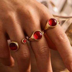 Luxurious gold-plated stainless steel open ring featuring a round red garnet cabochon