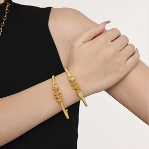 Minimalist gold plated spring coil open cuff bracelet for women featuring wavy texture
