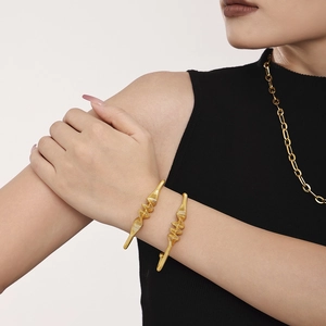 Modern gold plated stainless steel open bangles featuring unique wave textured design