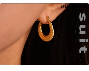 Macro shot of 18K gold plated stainless steel U-shape earring with textured finish