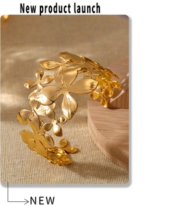 Detailed view of a gold floral cuff bracelet with intricate layered flowers and leaves