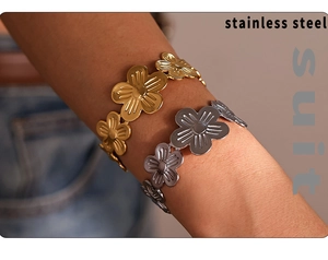 Detail of PVD gold-plated five-petal flower open bangles in stainless steel on wrist
