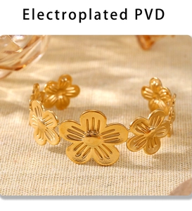 Macro detail of gold flower cuff bracelet with premium PVD electroplating finish