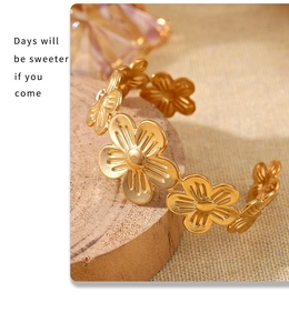 Detail of 18K gold plated flower pattern texture on adjustable open bangle cuff