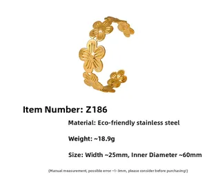 Macro detail of golden stainless steel flower bracelet showing 25mm width and floral texture