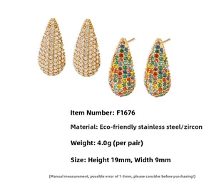 Macro shot of colorful and clear teardrop earrings in 18K gold plated stainless steel