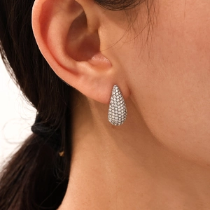 Elegance teardrop earrings with pavé white zircon and 18K gold PVD plating on model