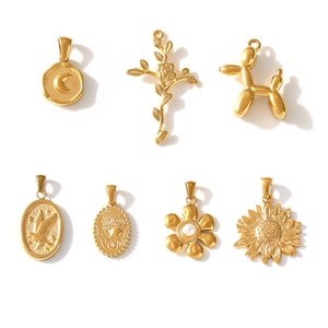Set of 7 gold-plated geometric pendants including moon, rose and balloon dog designs