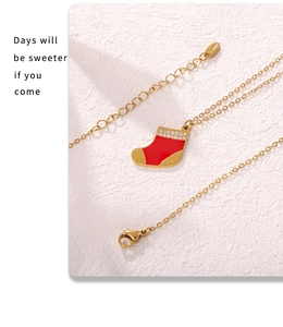 Gros plan du collier chaussette de Noël en émail rouge avec zircons et étiquette S.steel