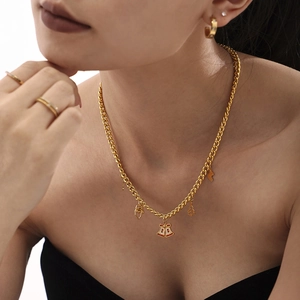 Golden Christmas necklace set with zircon bells and tree charms on a female model