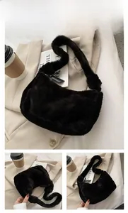 Close-up of black faux fur shoulder bag showing soft plush texture and crescent design