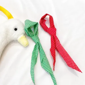 Cute white plush duck shoulder bag with interchangeable red polka dot and green plaid scarves