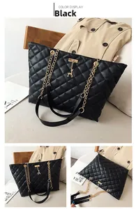 Detail of black quilted tote bag with gold chain strap and deer metal charm