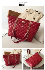 Macro shot of red quilted faux leather texture with gold metal chain and deer charm