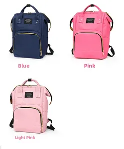 Three diaper backpacks in navy blue and pink showing waterproof fabric and large openings
