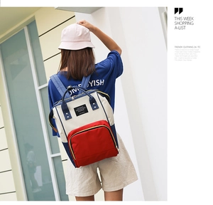 Outdoor shot of the multi-functional mommy backpack with tri-color splice design