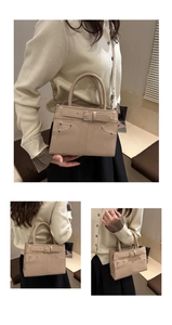 Detailed view of beige crossbody bag showing silver studs and metal buckle strap details