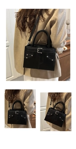 Three-way view of a black crossbody bag with silver buckles and stud details on a model