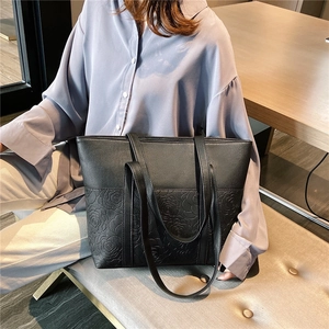 Black large capacity tote bag with embossed rose pattern and long shoulder straps