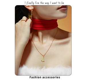 Detail of gold Christmas tree pendant necklace with zircon inlay on model neck