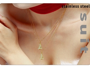 Detailed close-up of double-layered gold stainless steel necklace with Christmas tree pendant
