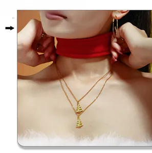 Close-up of double-layer gold Christmas tree necklace with zircon stones on a model