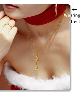Detailed close-up of double layer gold stainless steel necklace with zircon Christmas tree charms