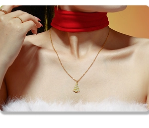Detail of Christmas tree pendant necklace with white zircon on elegant gold chain