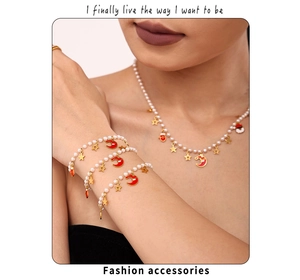 Detail of Christmas pearl jewelry set with red enamel santa and golden star charms