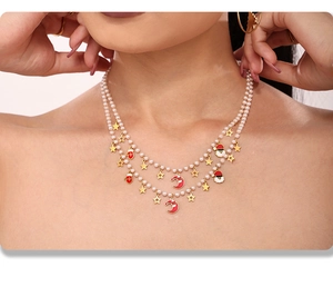 Double-layer pearl necklace with festive Santa Claus and gold star charms on a model
