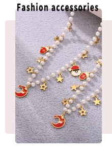 Detail of Christmas beaded necklace with Santa charms and pearls on soft plush texture