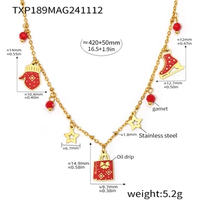 Detail showing gold stainless steel necklace with red garnet beads and winter charms
