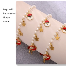 Detail of Christmas beaded bracelet set with enamel Santa charms and faux pearls