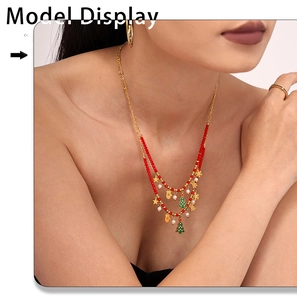 Close-up of double-layered Christmas necklace with red beads and enamel charms on model