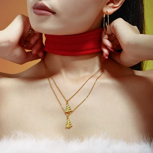 Double-layered gold-plated necklace with zircon-studded Christmas tree pendants on a model