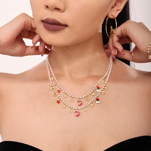 Christmas necklace and earrings set with enamel pendants and pearls on a model
