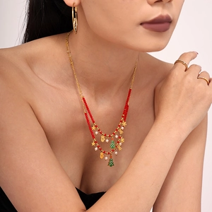 Double-layered Christmas necklace with green tree, red beads and gold star charms