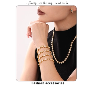 Model wearing gold layered necklace and bracelet set with zircon inlays and colorful earrings