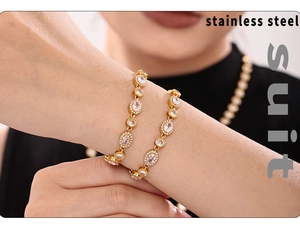 Close-up of 18K gold-plated stainless steel bracelet and necklace set with sparkling stones