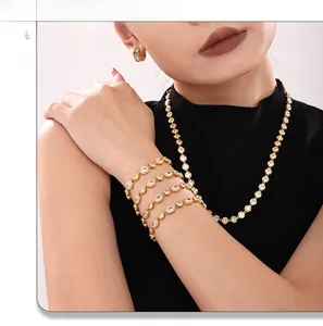 Detailed view of 18K gold plated tennis jewelry set with zircon stones on a model
