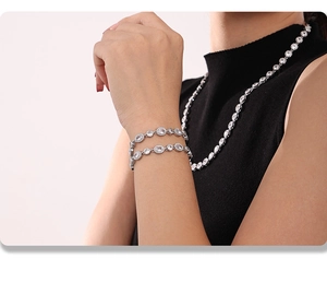 Close-up of sparkling zircon-studded silver bracelet on model with black outfit