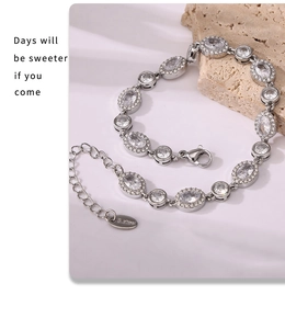 Detailed close-up of stainless steel bracelet with zircon inlay and lobster clasp