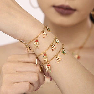 Golden Christmas bracelet with enamel HAPPY letter pendants and zircon inlay for festive style