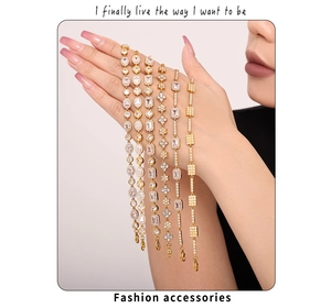 Macro shot of assorted gold-plated bracelets featuring cubic zirconia on a model's wrist