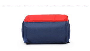 Detail of red and blue color-block multifunctional travel bag with gold metal zipper