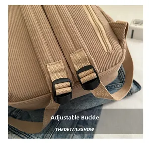 Detail of khaki corduroy backpack with black adjustable shoulder strap buckle