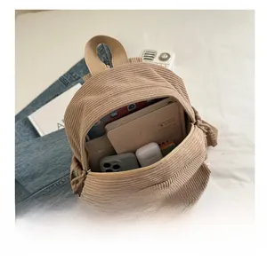 Corduroy mini backpack interior showing capacity for tablets and books