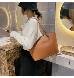 Detail einer braunen Leder-Tragetasche mit FASHION-Text und großem Fassungsvermögen