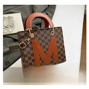 Detail of vintage monogram small tote bag with leather M patch and round handle